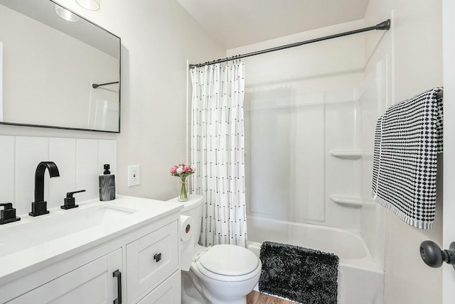 bathroom with toilet, shower / bathtub combination with curtain, and vanity