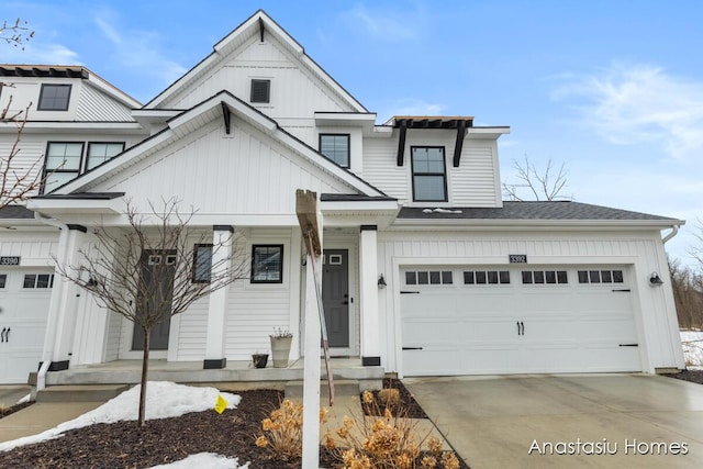 view of front of home featuring board and batten siding, concrete driveway, a shingled roof, and a garage