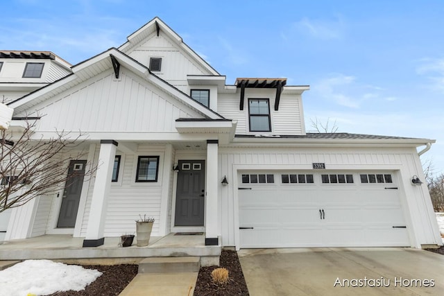 view of front of home featuring driveway, an attached garage, and board and batten siding