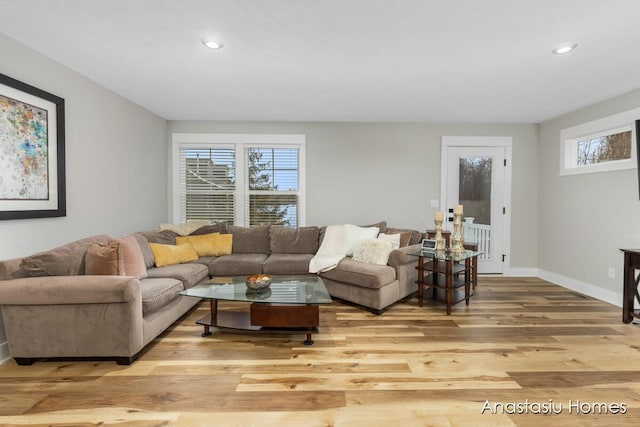 living room with baseboards, a wealth of natural light, light wood-style flooring, and recessed lighting