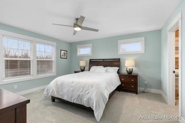 bedroom with baseboards, ceiling fan, and light colored carpet