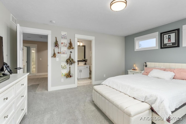 bedroom with light colored carpet, connected bathroom, visible vents, and baseboards