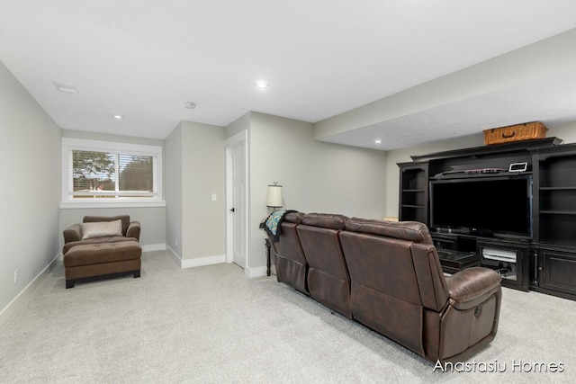 living area featuring baseboards, recessed lighting, visible vents, and light colored carpet