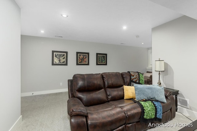 living room featuring visible vents, light carpet, and baseboards