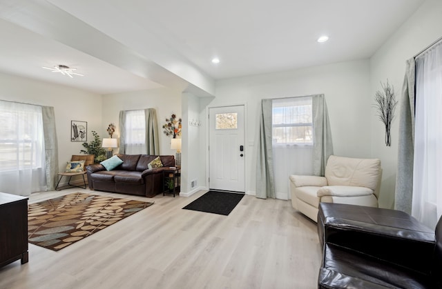 foyer with light wood finished floors, baseboards, and recessed lighting