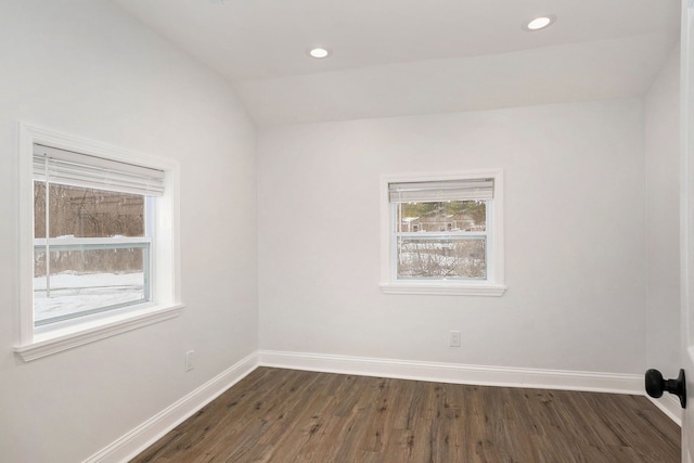 unfurnished room featuring lofted ceiling, dark wood-type flooring, recessed lighting, and baseboards