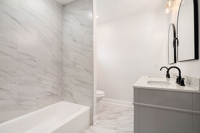 bathroom featuring marble finish floor, double vanity, toilet, a sink, and baseboards