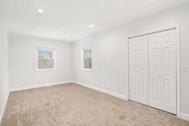 unfurnished bedroom with recessed lighting, carpet flooring, and baseboards