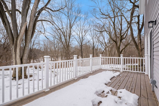 yard covered in snow with a wooden deck