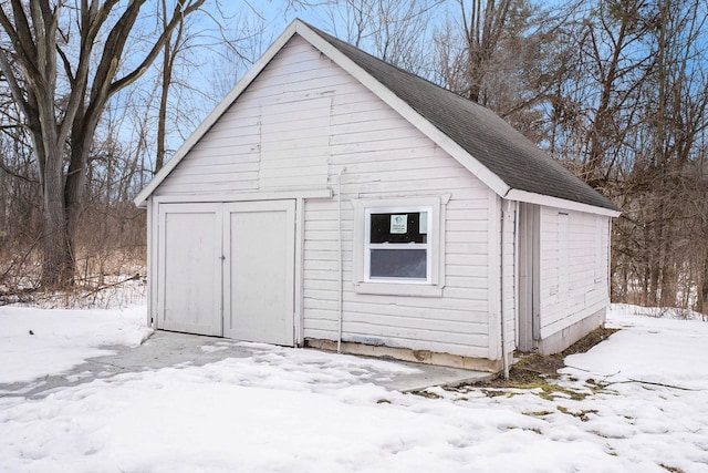 snow covered structure featuring an outdoor structure