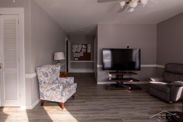 living room featuring wood finished floors, a ceiling fan, and baseboards