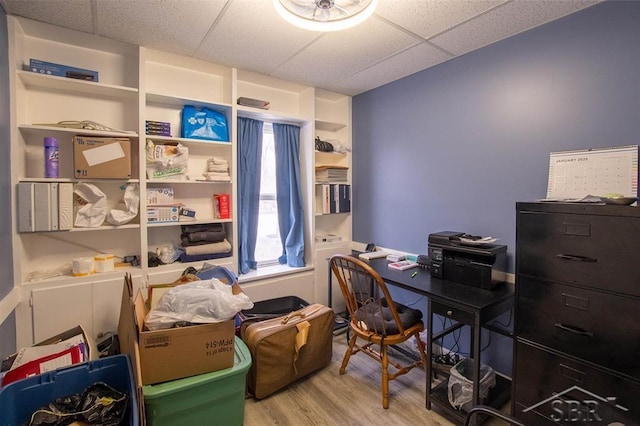 office space featuring light wood finished floors and a paneled ceiling