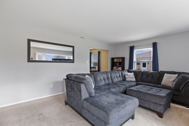 living room with baseboards, visible vents, and light colored carpet