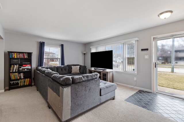 living room featuring light colored carpet and baseboards