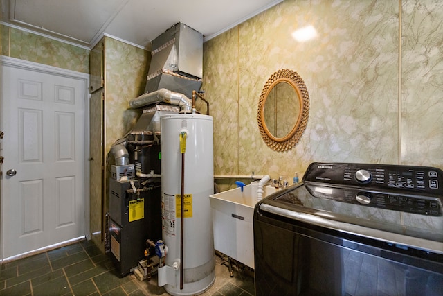 laundry area with gas water heater, a sink, washer / dryer, laundry area, and wallpapered walls