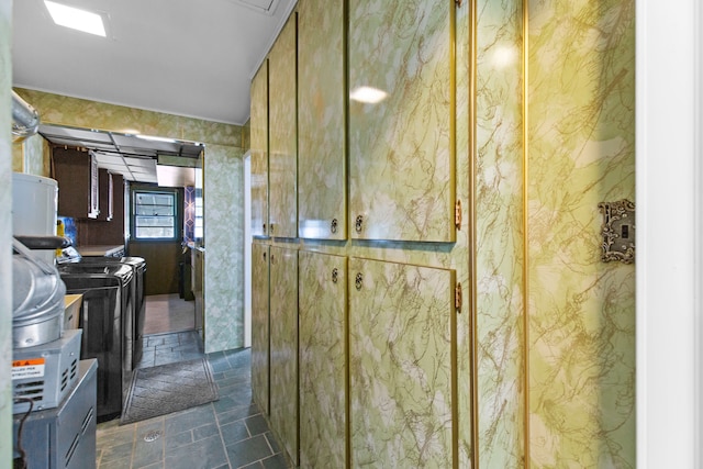 interior space featuring stone finish floor and washer and clothes dryer