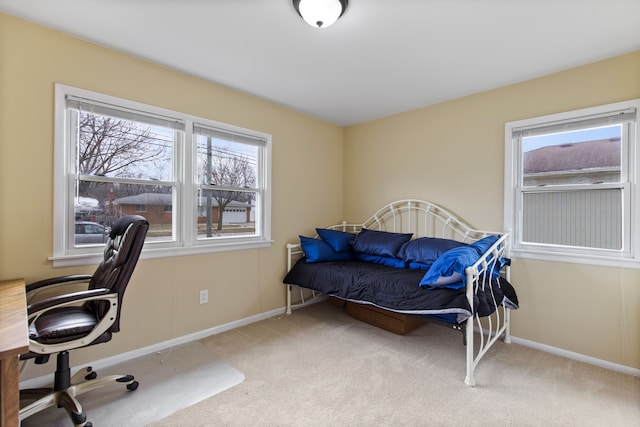 carpeted bedroom featuring baseboards