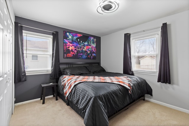 carpeted bedroom with baseboards