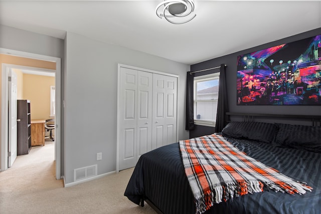 carpeted bedroom with a closet, visible vents, and baseboards