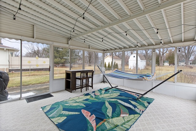 sunroom / solarium featuring vaulted ceiling