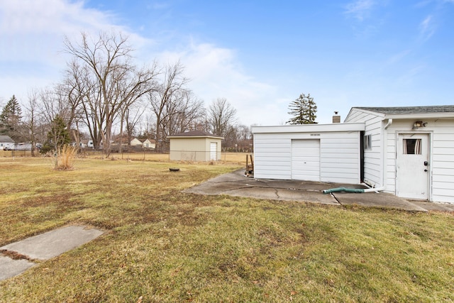 view of yard featuring fence and an outdoor structure