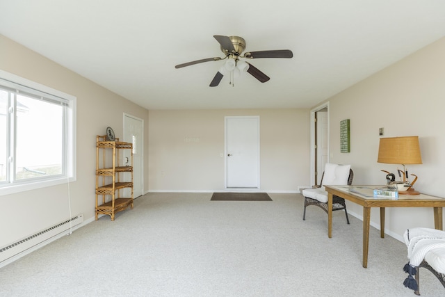 living area featuring carpet floors, baseboard heating, a ceiling fan, and baseboards