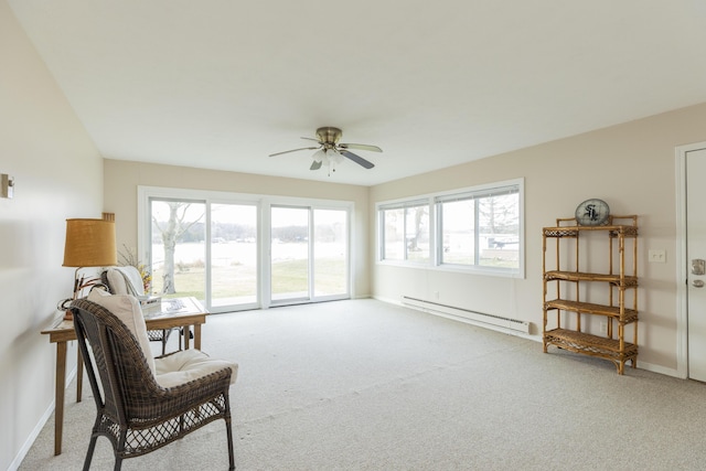 living area featuring light carpet, a baseboard radiator, a wealth of natural light, and baseboards