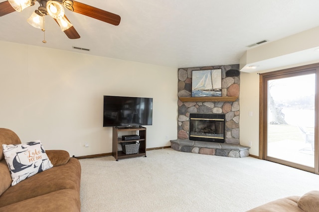 living area with a fireplace, carpet flooring, visible vents, and baseboards