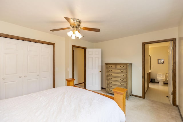 bedroom with a closet, light carpet, connected bathroom, ceiling fan, and baseboards