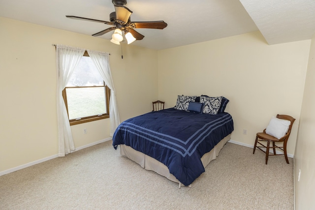 bedroom with a ceiling fan, light colored carpet, and baseboards