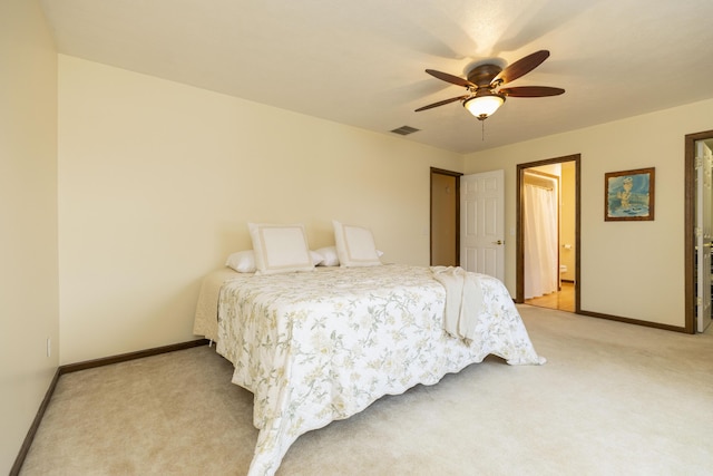 bedroom featuring baseboards, ceiling fan, visible vents, and light colored carpet