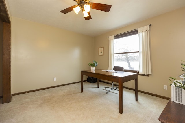 office with a ceiling fan, light colored carpet, and baseboards