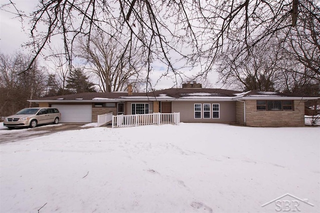 ranch-style home with an attached garage and a chimney