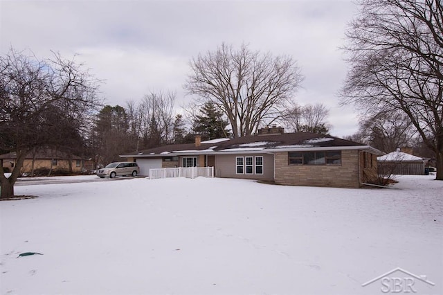 view of front of house with a garage and a chimney