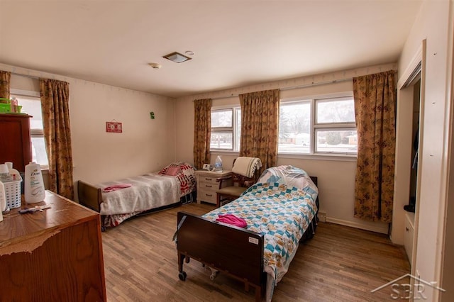 bedroom featuring baseboards and wood finished floors