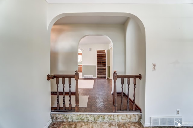 hall with visible vents and baseboards