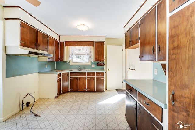 kitchen with light floors, light countertops, and a sink