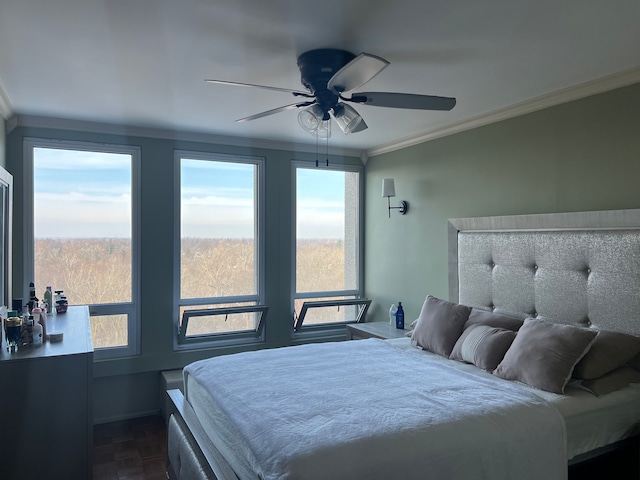 bedroom featuring ceiling fan, multiple windows, and ornamental molding