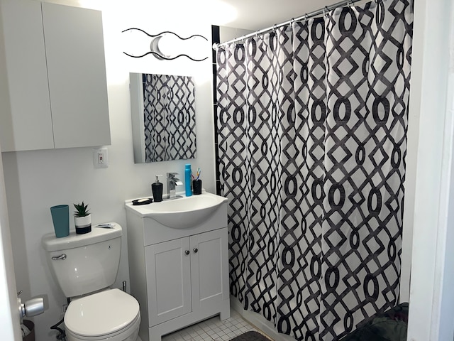 bathroom with tile patterned flooring, a shower with curtain, vanity, and toilet