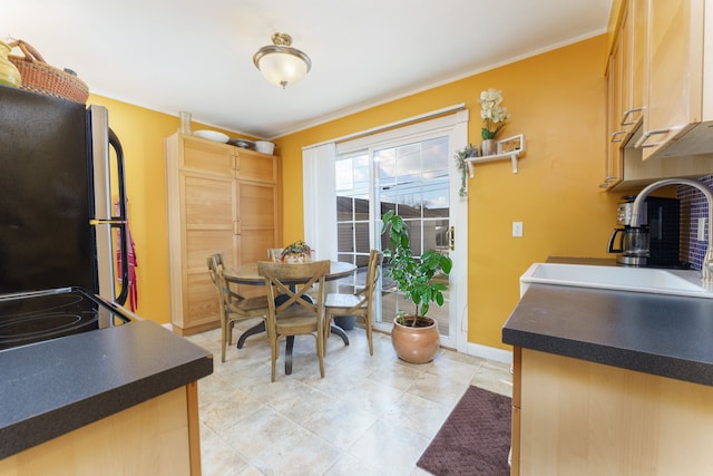 dining room featuring ornamental molding and baseboards