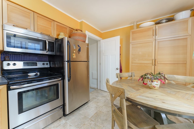 kitchen with light tile patterned floors, light brown cabinets, appliances with stainless steel finishes, decorative backsplash, and crown molding