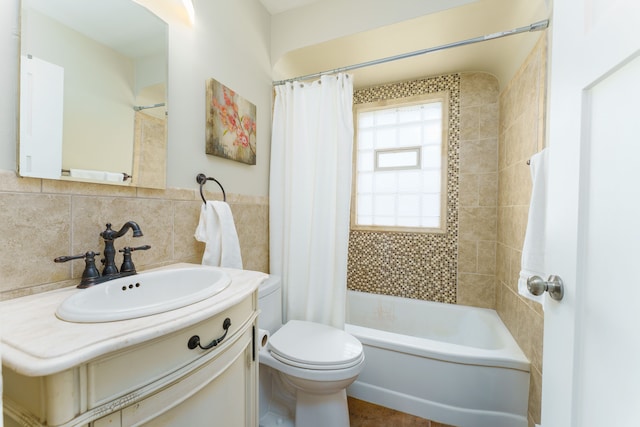 full bathroom with toilet, backsplash, shower / bathtub combination with curtain, vanity, and tile walls