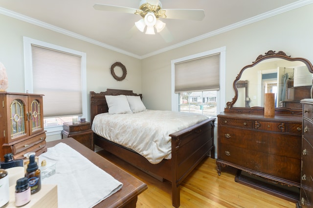 bedroom featuring light wood-type flooring, ceiling fan, and ornamental molding