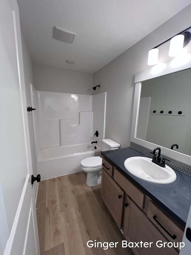 1910 Fallasburg Park Dr NE Unit 5, Lowell, MI 49331 - full bath featuring wood finished floors, bathtub / shower combination, vanity, and toilet