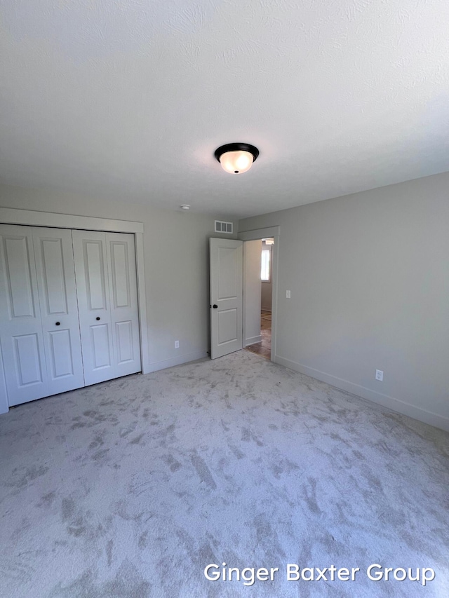 1910 Fallasburg Park Dr NE Unit 5, Lowell, MI 49331 - unfurnished bedroom featuring baseboards, a closet, and carpet floors
