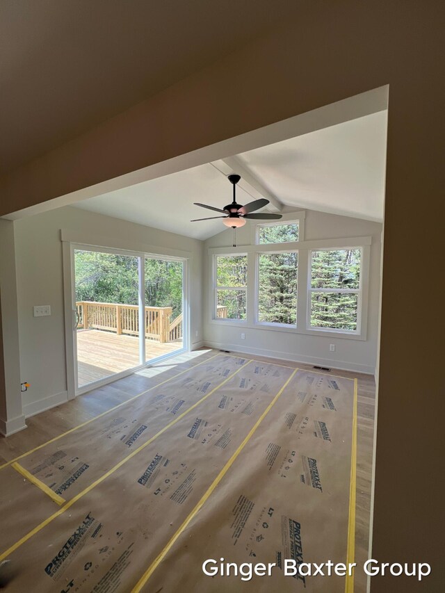 1910 Fallasburg Park Dr NE Unit 5, Lowell, MI 49331 - empty room with lofted ceiling, ceiling fan, plenty of natural light, baseboards, and wood finished floors