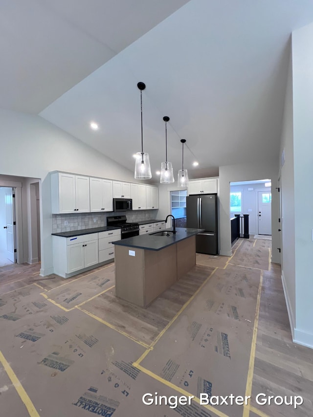 1910 Fallasburg Park Dr NE Unit 5, Lowell, MI 49331 - kitchen with black appliances, dark countertops, lofted ceiling, a sink, and backsplash