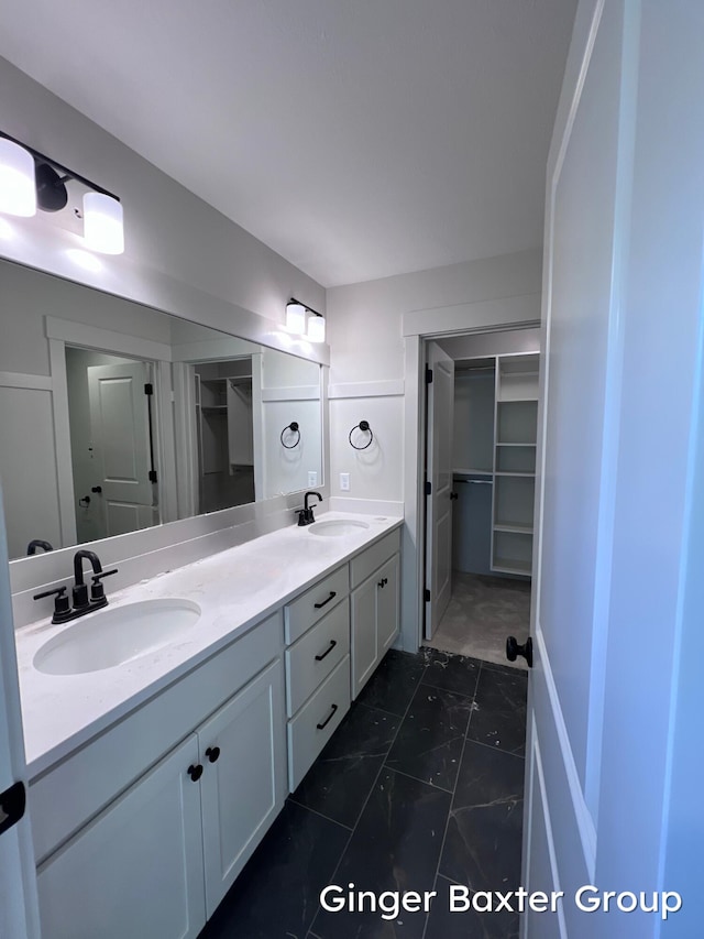 1910 Fallasburg Park Dr NE Unit 5, Lowell, MI 49331 - full bathroom with double vanity, a walk in closet, and marble look tile flooring