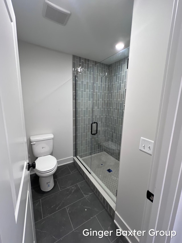 1910 Fallasburg Park Dr NE Unit 5, Lowell, MI 49331 - bathroom featuring a shower stall, toilet, marble finish flooring, and baseboards