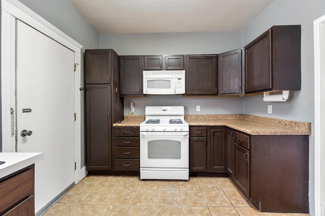 kitchen featuring white appliances, light countertops, dark brown cabinets, and light tile patterned floors